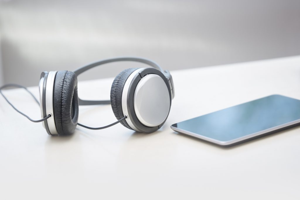 Headphones and digital tablet on a table